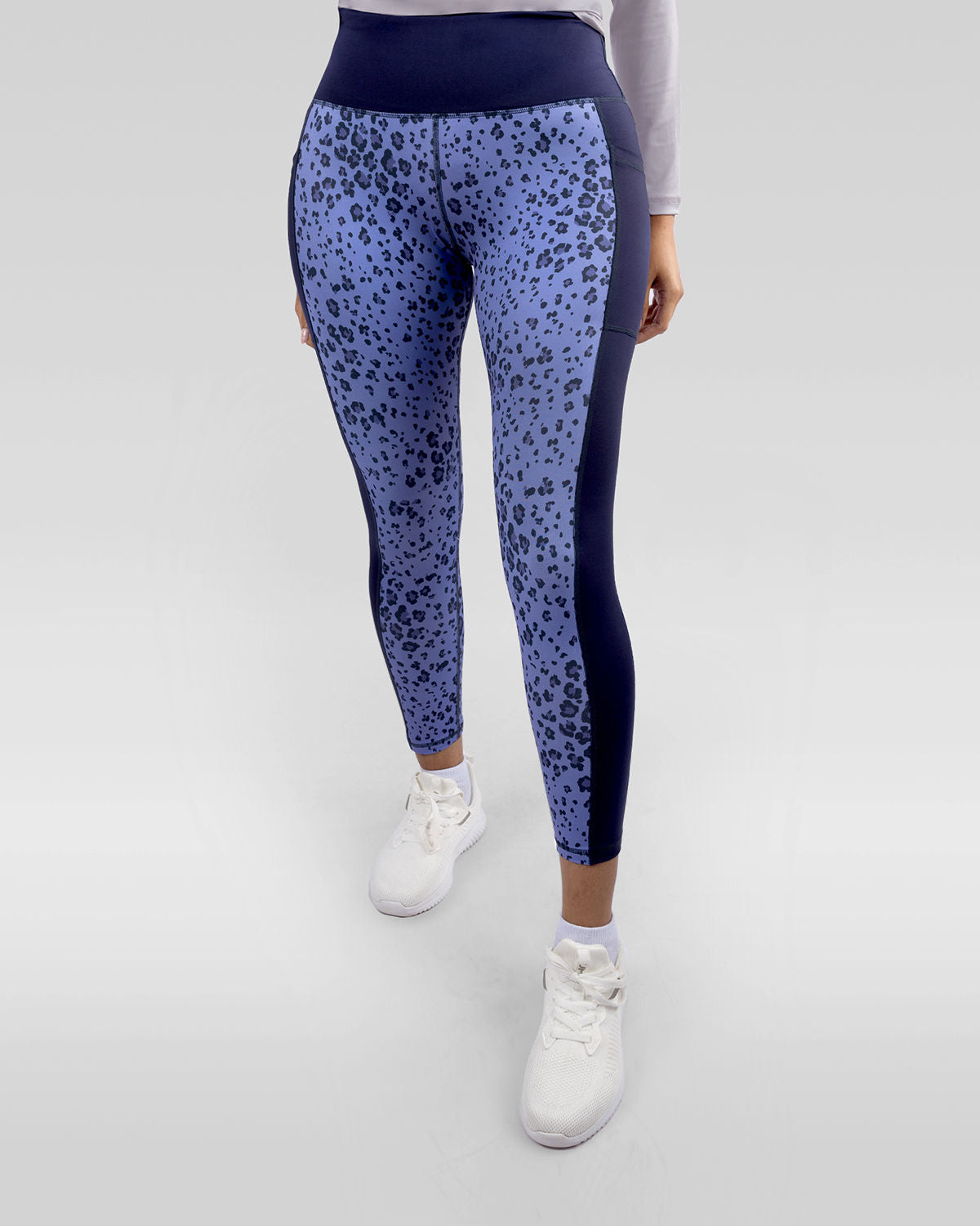 Photo by ð—”ð—§ð—¨ð— SPORTSWEAR Â® on December 20, 2022. May be an image of 1 woman wears printed purple/navy floral leggings, and white shoes.