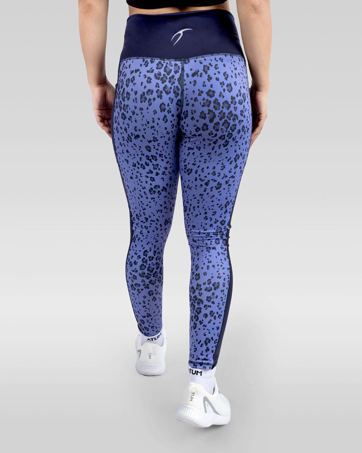 Photo by ð—”ð—§ð—¨ð— SPORTSWEAR Â® on December 20, 2022. May be an image of 1 woman wears printed purple/navy floral leggings, and white shoes.